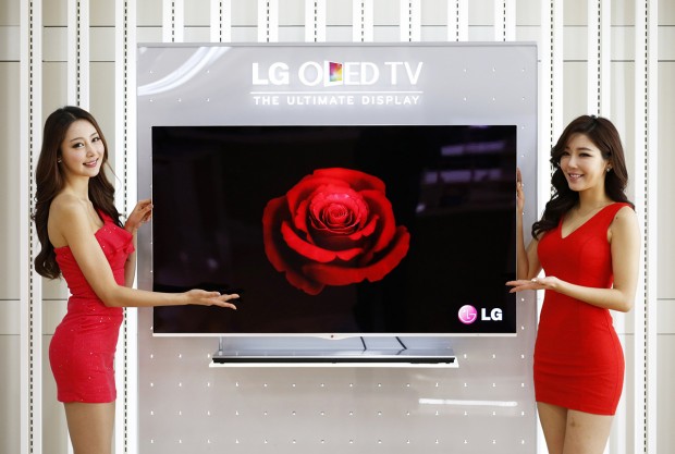 Models pose next to a LG Electronics' OLED television in Seoul