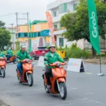 Grab Việt Nam và Dat Bike hợp tác hỗ trợ tài xế công nghệ chuyển đổi xanh với xe máy điện